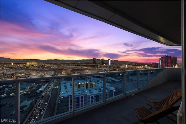 balcony with a mountain view and a city view