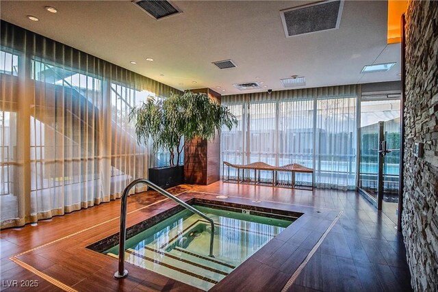 view of pool featuring an indoor hot tub