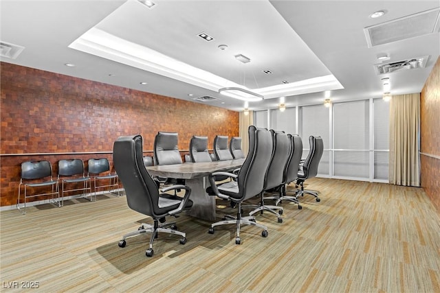 office with visible vents, a raised ceiling, and carpet floors