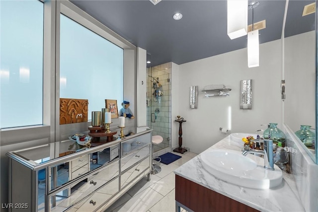 bathroom featuring double vanity, tile patterned floors, a stall shower, and a sink