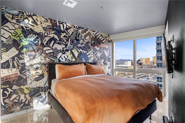 bedroom featuring a city view and visible vents