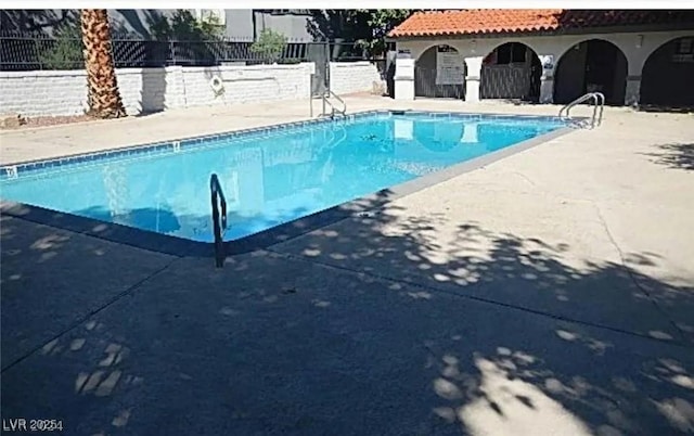 pool featuring a patio and fence