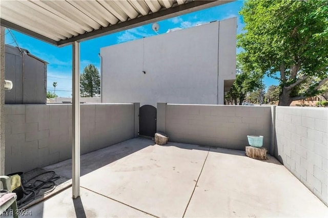 view of patio with a gate and fence