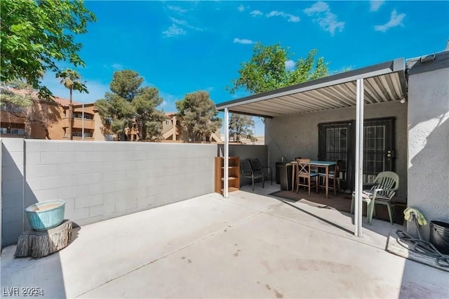 view of patio / terrace featuring outdoor dining area and fence