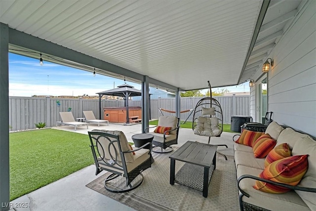 view of patio featuring a gazebo, an outdoor living space, a fenced backyard, and a hot tub