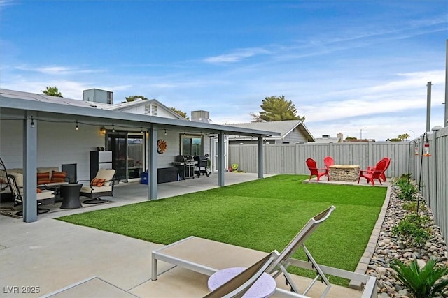 view of yard with a patio, a fire pit, and a fenced backyard