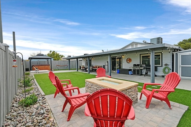 view of patio / terrace with a gazebo, a grill, a fenced backyard, and a hot tub