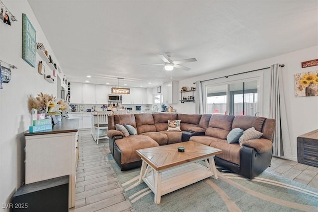 living room featuring recessed lighting, light wood-style floors, and ceiling fan