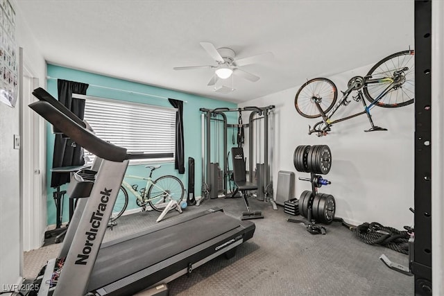 workout area featuring baseboards and ceiling fan