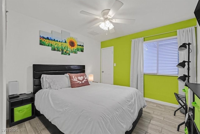 bedroom featuring visible vents, wood finished floors, baseboards, and ceiling fan