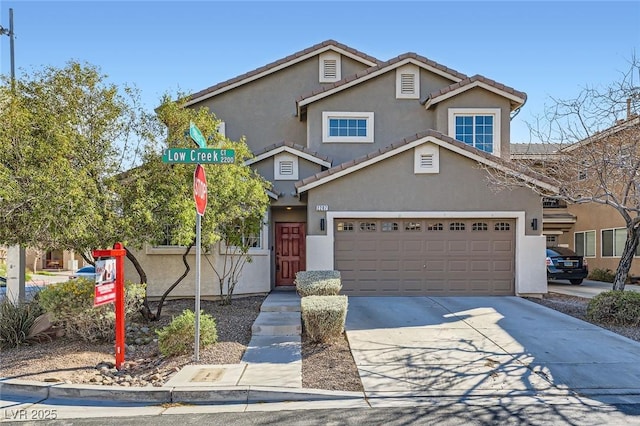 traditional-style house featuring a tile roof, concrete driveway, and stucco siding