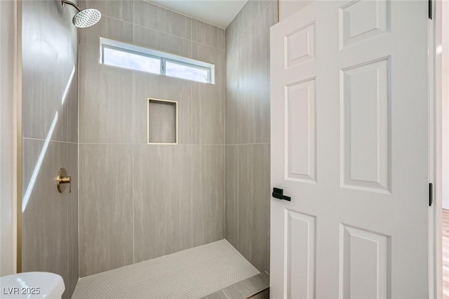 bathroom with a tile shower