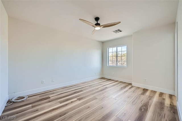 interior space featuring visible vents, light wood-style flooring, a ceiling fan, and baseboards