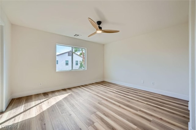 empty room featuring visible vents, baseboards, a ceiling fan, and light wood finished floors