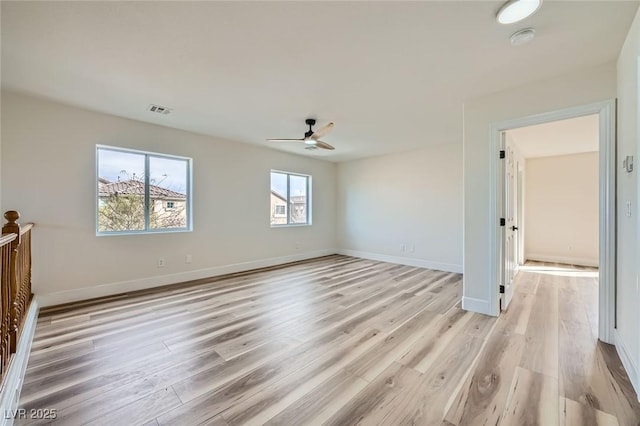 unfurnished bedroom featuring ceiling fan, visible vents, baseboards, and light wood-style flooring