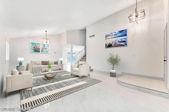 living area featuring visible vents, high vaulted ceiling, stairs, a notable chandelier, and marble finish floor