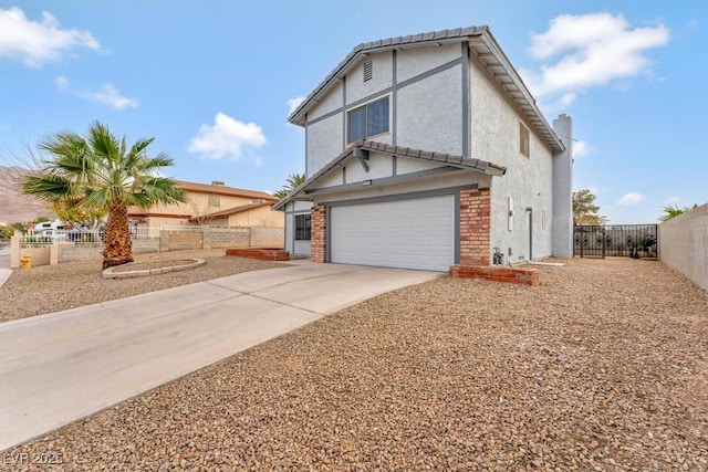 view of front of home with fence, an attached garage, a chimney, stucco siding, and concrete driveway