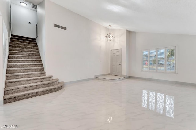 unfurnished living room with visible vents, baseboards, stairs, marble finish floor, and high vaulted ceiling