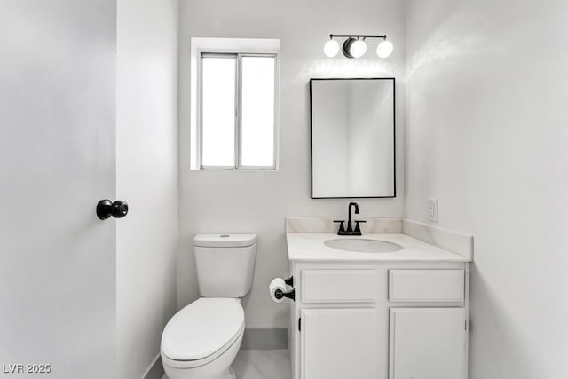 bathroom featuring toilet and vanity