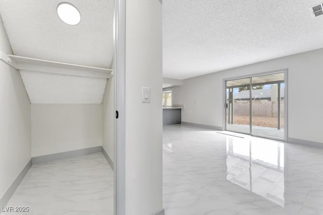 spacious closet featuring visible vents and marble finish floor