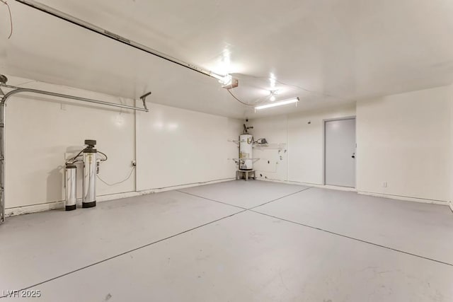 garage with strapped water heater and a garage door opener