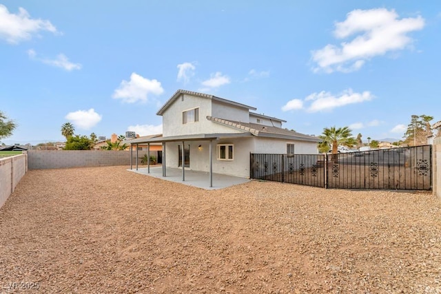 back of house with a patio area, a fenced backyard, and stucco siding