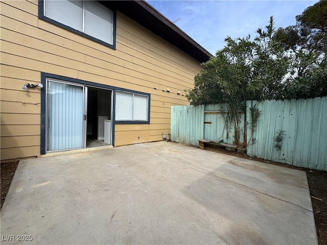 view of patio featuring fence