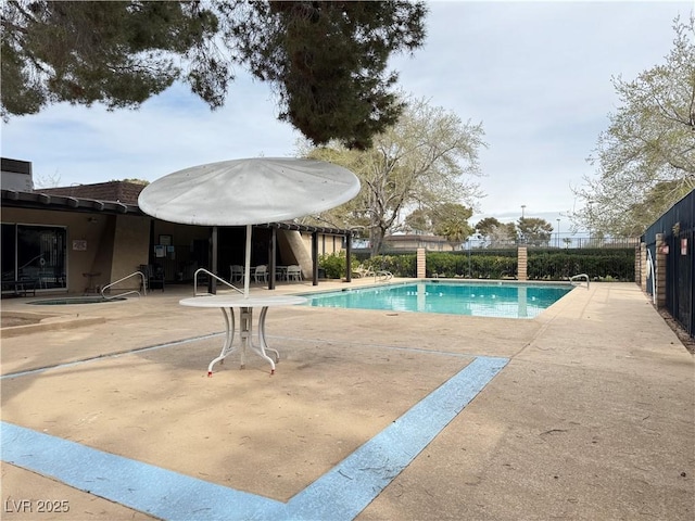 community pool featuring a patio and fence