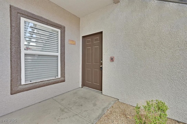 doorway to property with stucco siding