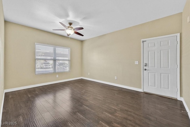 unfurnished room featuring dark wood-style floors, baseboards, and ceiling fan