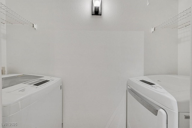 clothes washing area with laundry area and separate washer and dryer