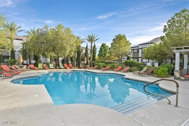 pool with a patio and fence