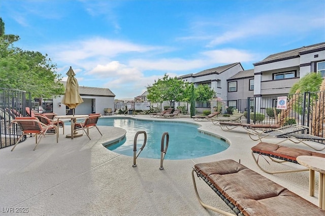 pool featuring a patio area and fence