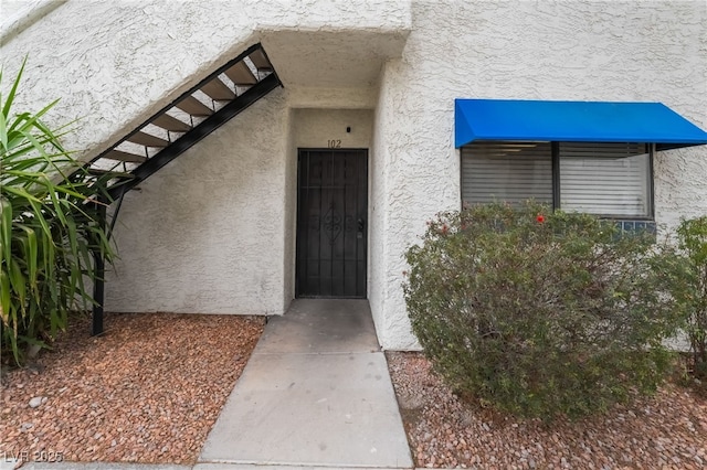 doorway to property with stucco siding