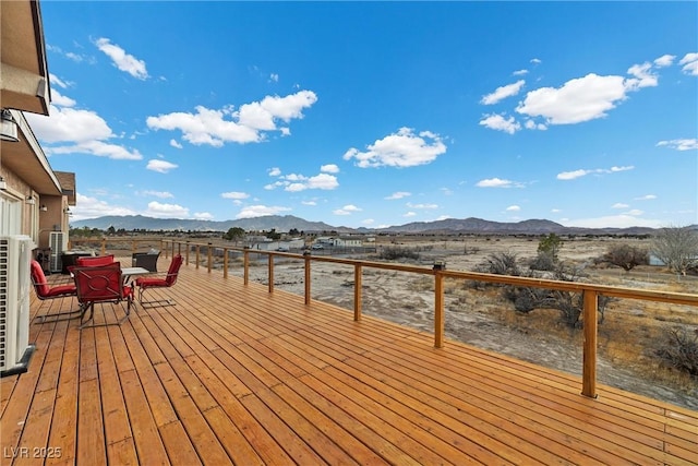 wooden deck featuring a mountain view