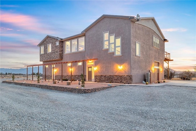 view of front of home with a patio area and stucco siding