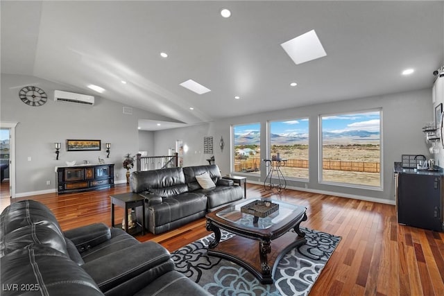 living room with lofted ceiling with skylight, wood finished floors, baseboards, and a wall mounted AC