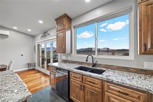 kitchen with baseboards, dishwasher, light stone counters, french doors, and a sink