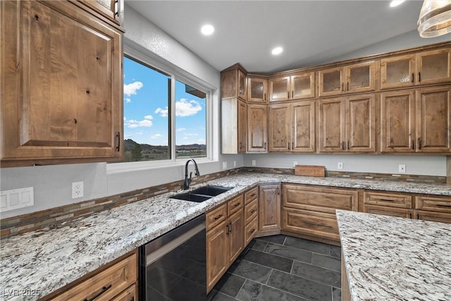 kitchen featuring a sink, brown cabinets, and dishwasher