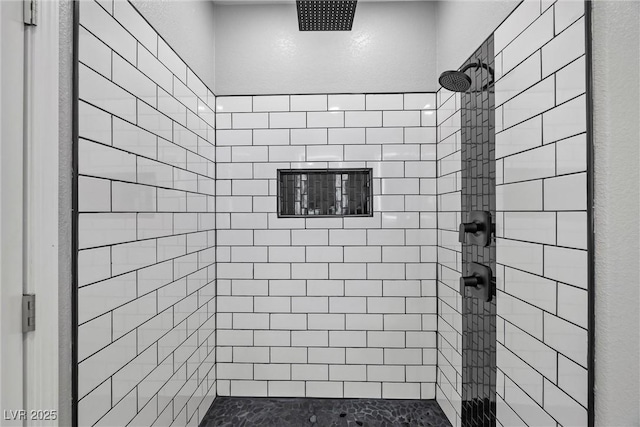 full bathroom with a tile shower