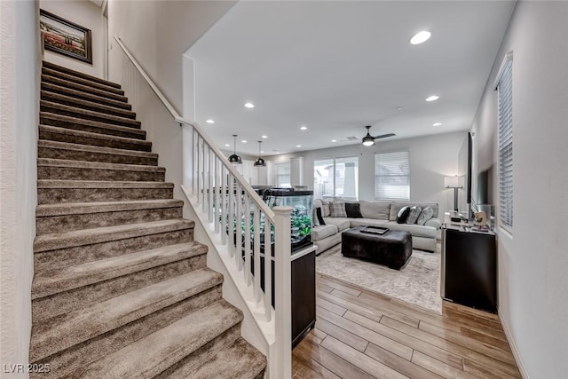 staircase featuring a ceiling fan, recessed lighting, and wood finished floors