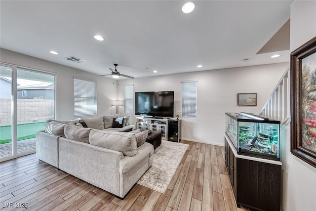 living area with visible vents, baseboards, light wood-type flooring, recessed lighting, and a ceiling fan