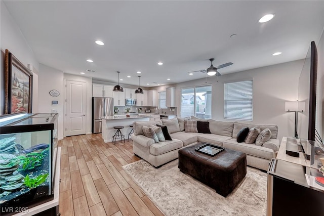 living room featuring recessed lighting, visible vents, ceiling fan, and light wood finished floors