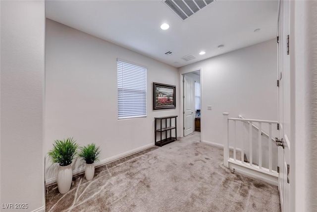 corridor with visible vents, an upstairs landing, recessed lighting, carpet flooring, and baseboards