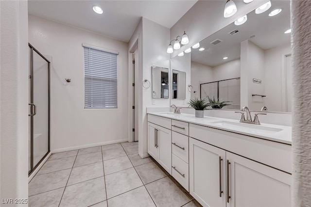 full bath with a sink, visible vents, a shower stall, and tile patterned floors