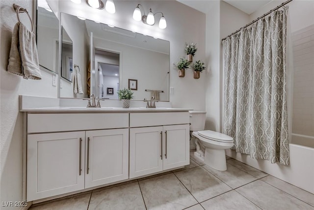 bathroom featuring tile patterned floors, toilet, and a sink