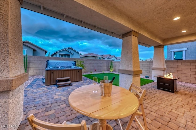 view of patio featuring a fenced backyard and a hot tub