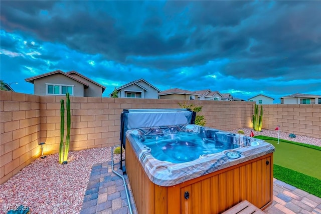 view of patio / terrace featuring a hot tub and a fenced backyard