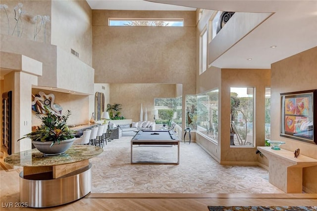 living room featuring visible vents, baseboards, and wood finished floors