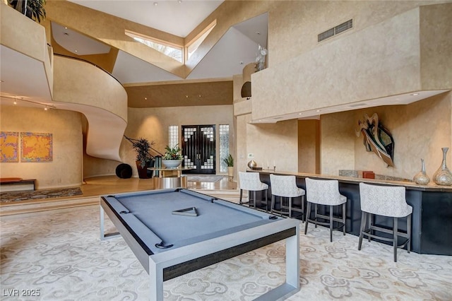 playroom with billiards, visible vents, a high ceiling, a skylight, and a community bar